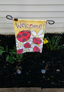 Yellow Welcome banner with ladybugs at the Author Chronicles' headquarters